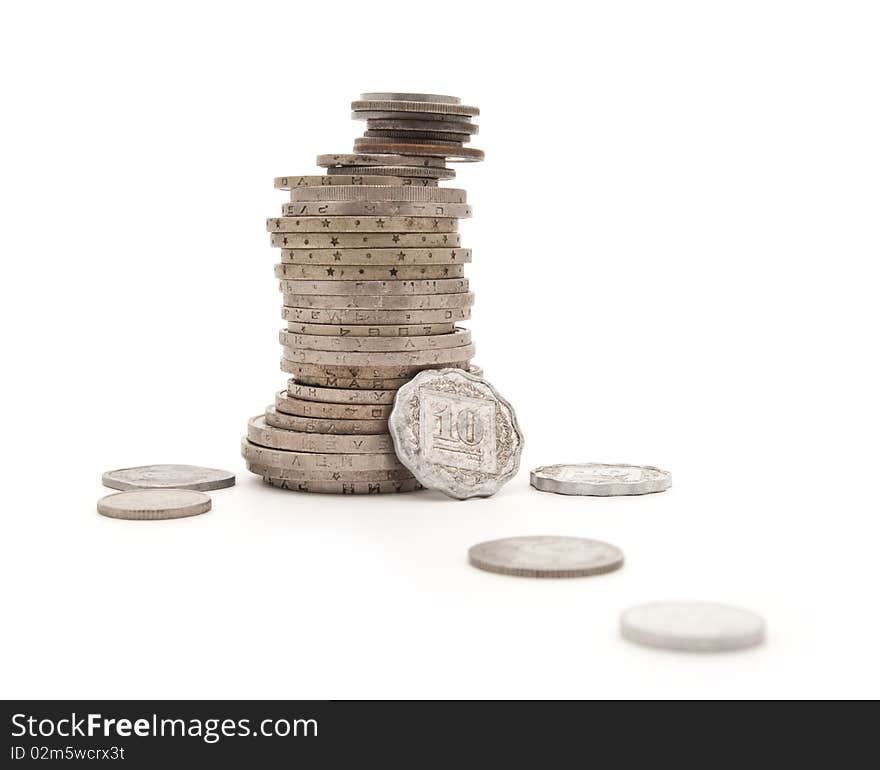 Various steel coins combined by a column on a white background