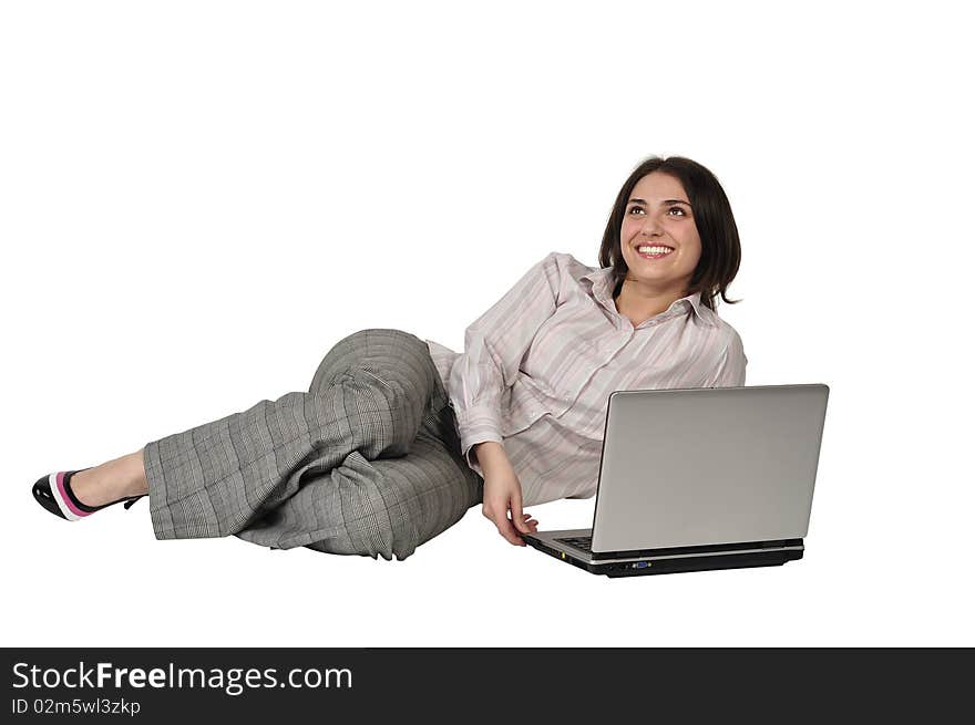 The beautiful girl laughs and lies on a floor with the laptop on a white background. The beautiful girl laughs and lies on a floor with the laptop on a white background