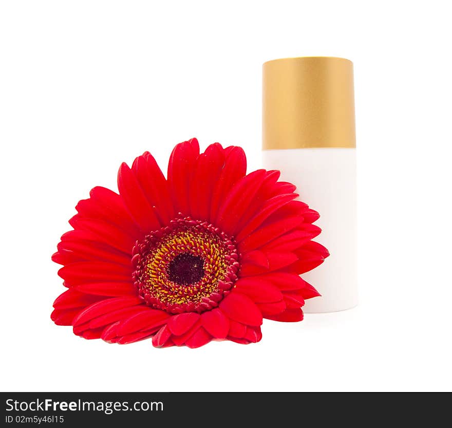 Cream bottle with a red gerberas on a white background