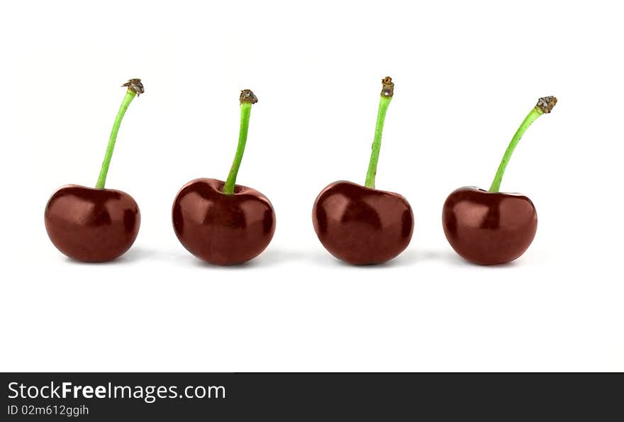 Four red cherries isolated on white background. Four red cherries isolated on white background