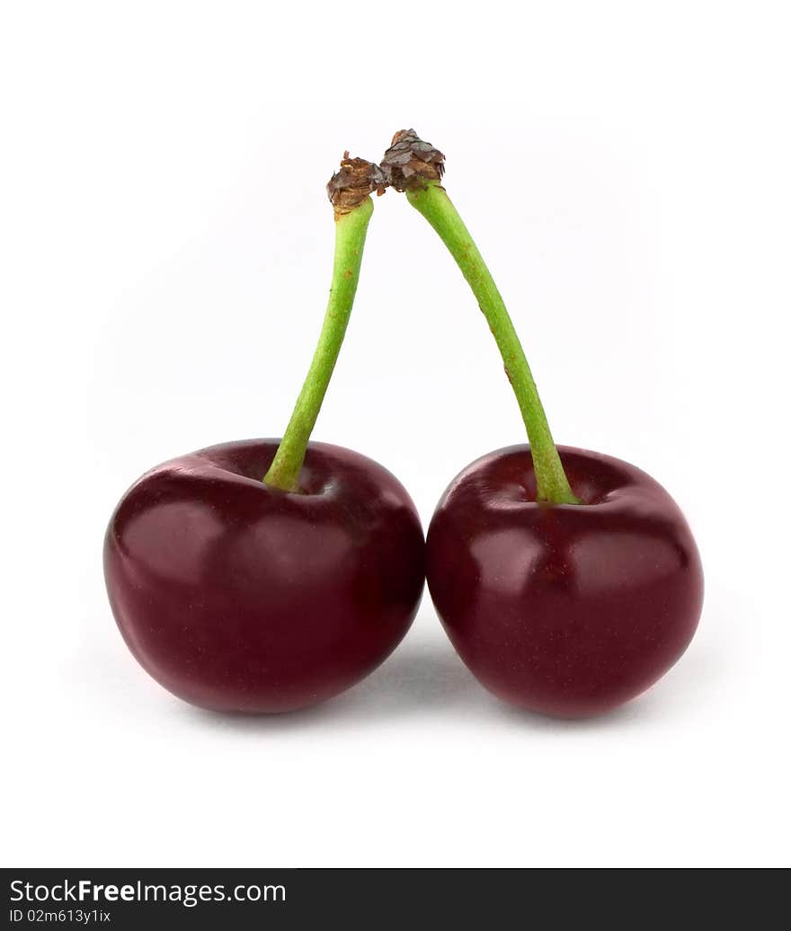 Two red cherries isolated on white background. Two red cherries isolated on white background