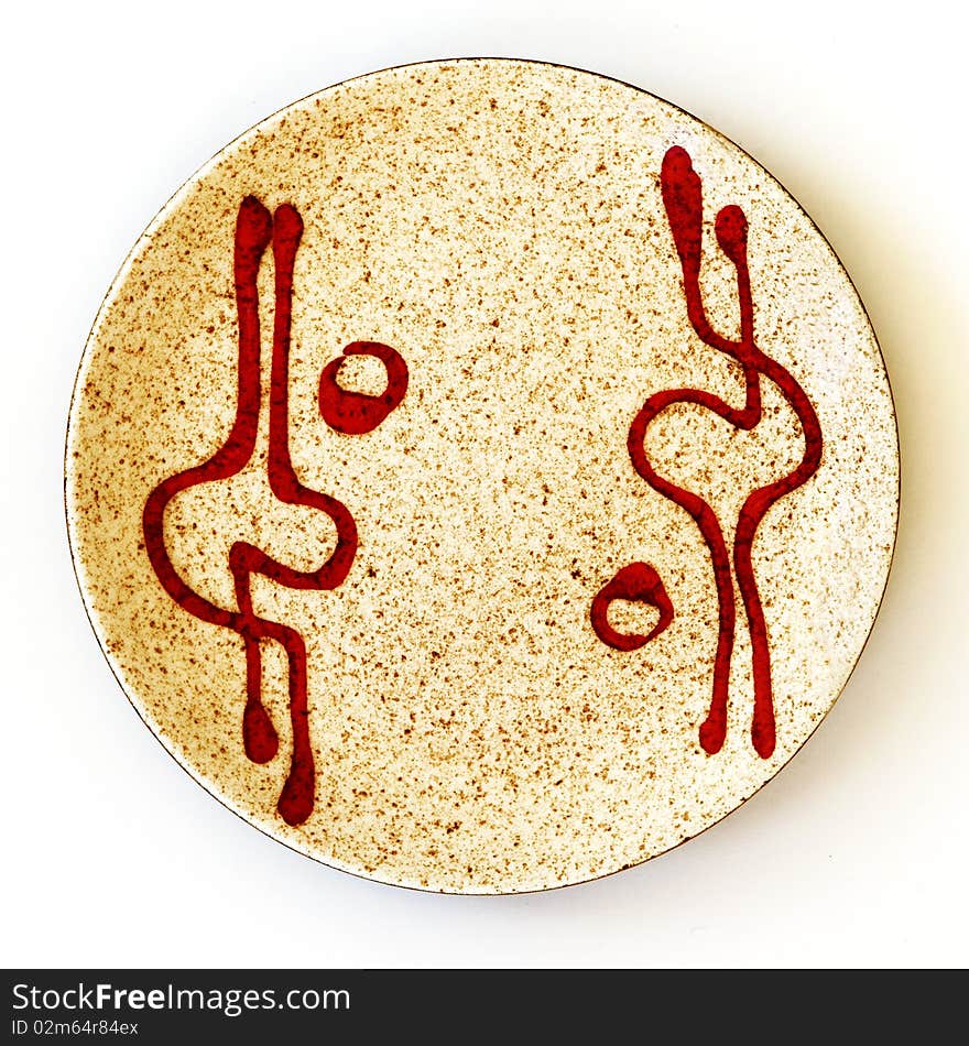 Closeup of Israeli ceramic circle plate of 1950th years with an image of the red graphical spots, reminding a human figures, on a light brown ceramic background. Closeup of Israeli ceramic circle plate of 1950th years with an image of the red graphical spots, reminding a human figures, on a light brown ceramic background.