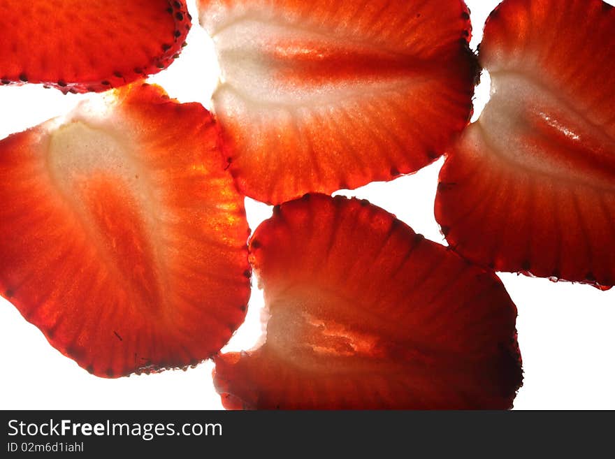 Close-up view of sliced strawberry in back light. Close-up view of sliced strawberry in back light