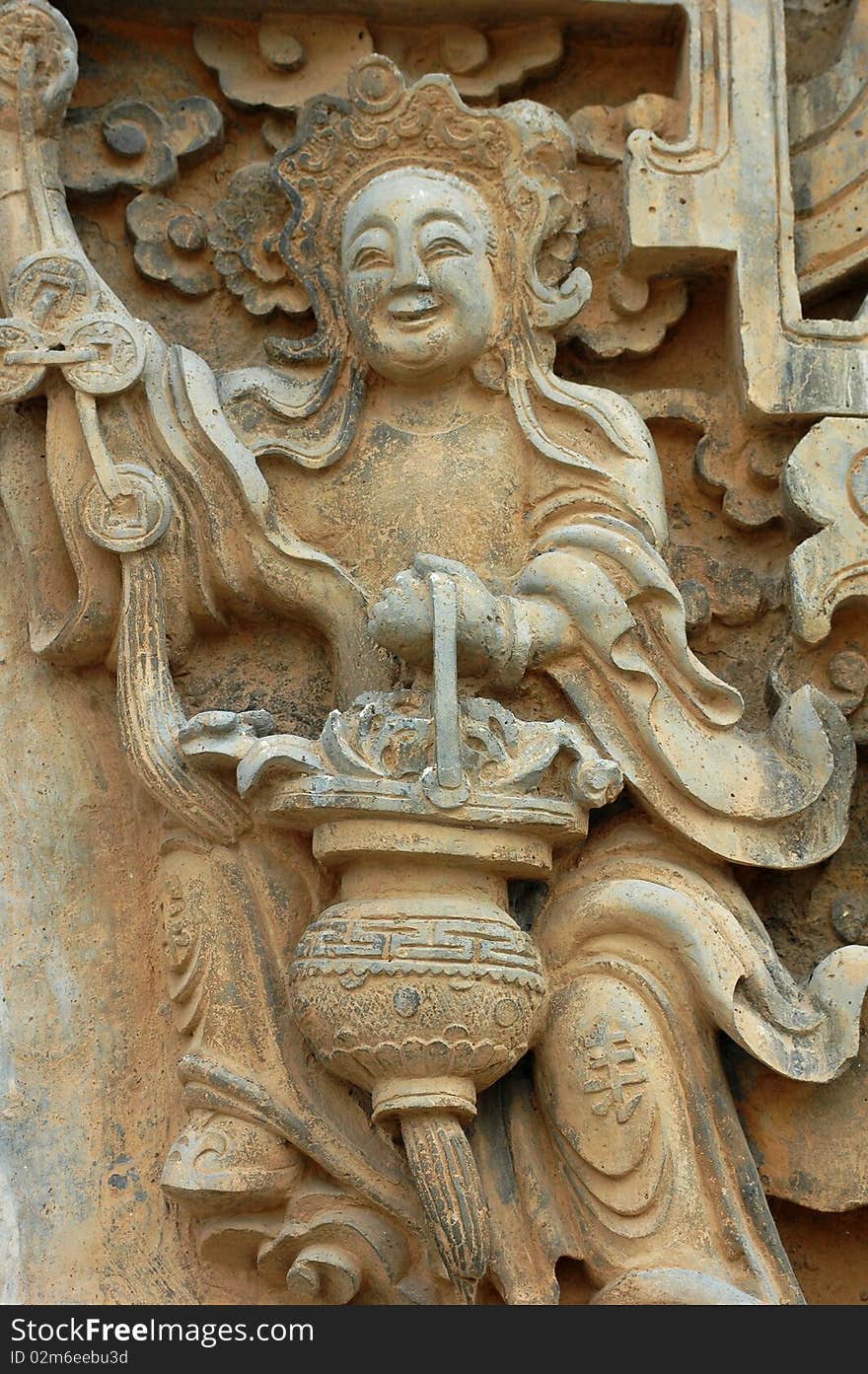 Stone sculpture of a smiling buddha holding a lantern