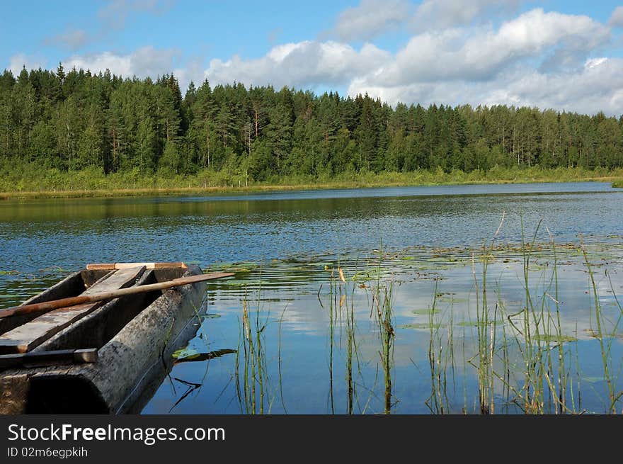 Old wooden boat at the lake bank