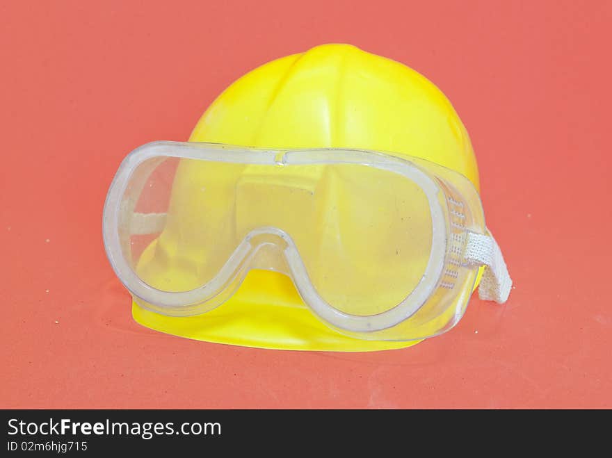 Yellow helmet with goggles red background