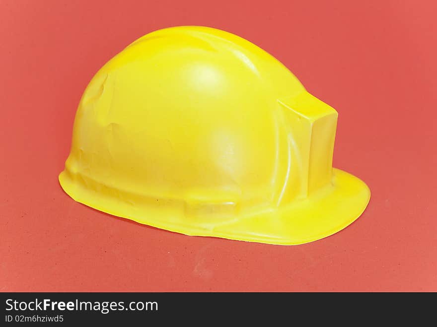 Yellow  helmet isolated on red background