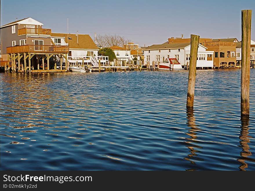 An intercoastal waterway with homes in the background. An intercoastal waterway with homes in the background