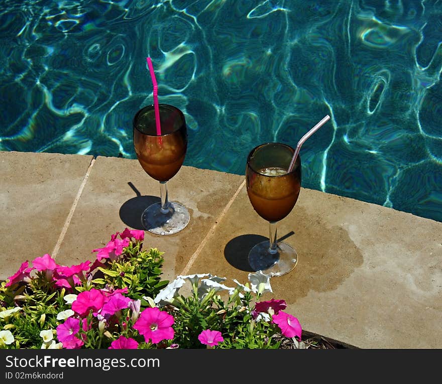 Relaxing drinks by an inviting pool in the summer. Relaxing drinks by an inviting pool in the summer.