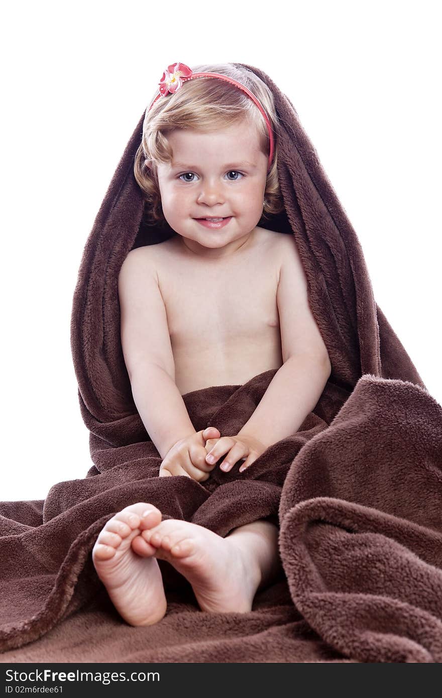 Beautiful baby under a brown towel