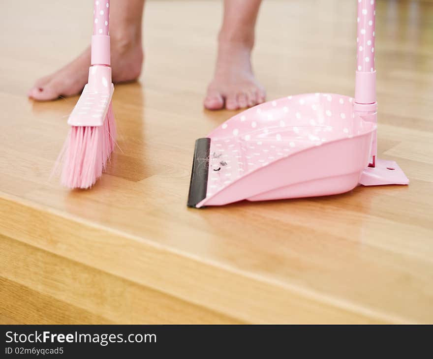 Cleaning the floor with a dust-brush