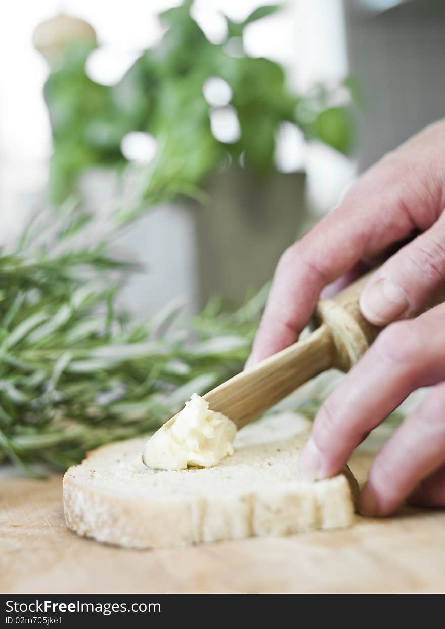 Human spreading butter on bread