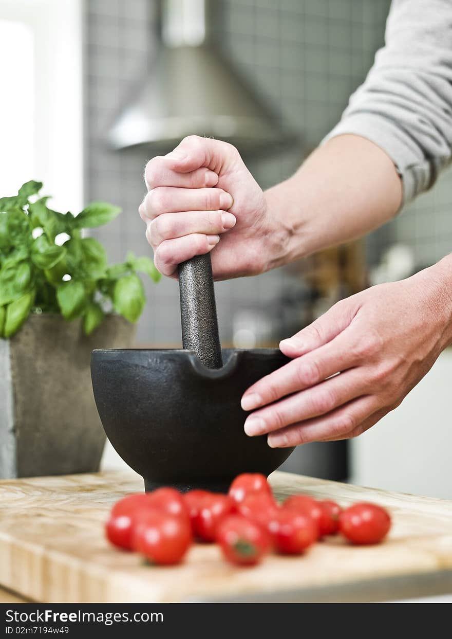 Human with a mortar in the kitchen