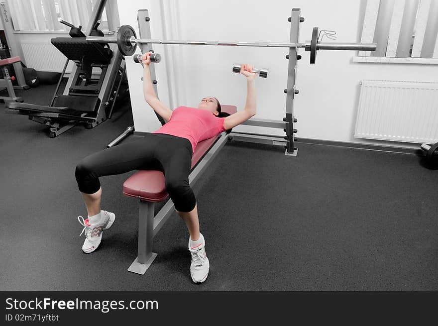 Young earopean woman making physical exercises in a gym. Young earopean woman making physical exercises in a gym