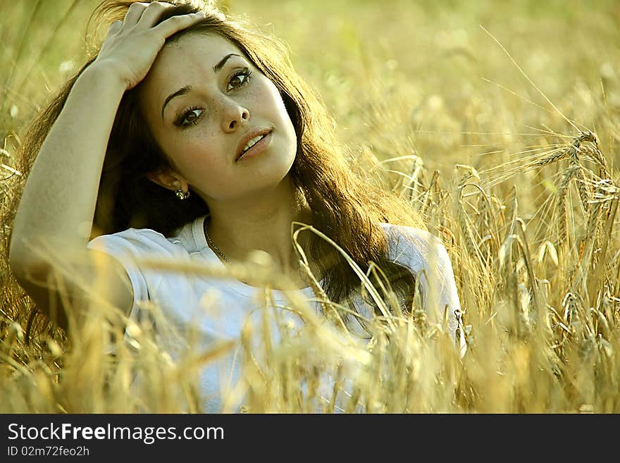 Tired girl resting in a field. Tired girl resting in a field