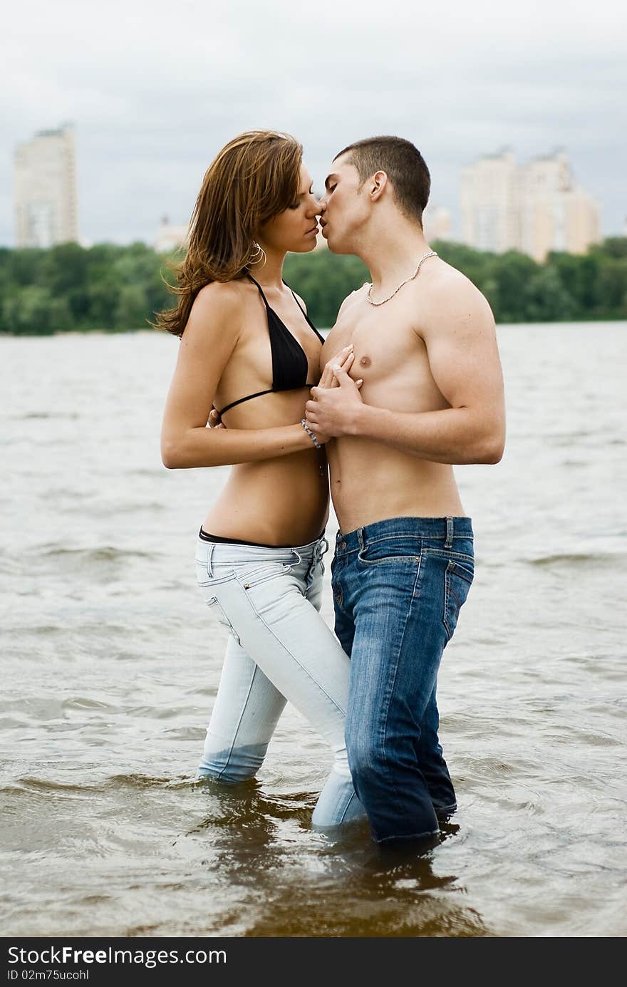 Couple on a river bank kissing and hugging