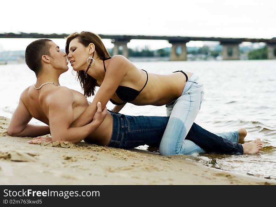 Couple on a river bank kissing and hugging