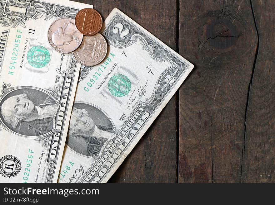 One and two old dollar bank notes and few coins on wooden background. One and two old dollar bank notes and few coins on wooden background