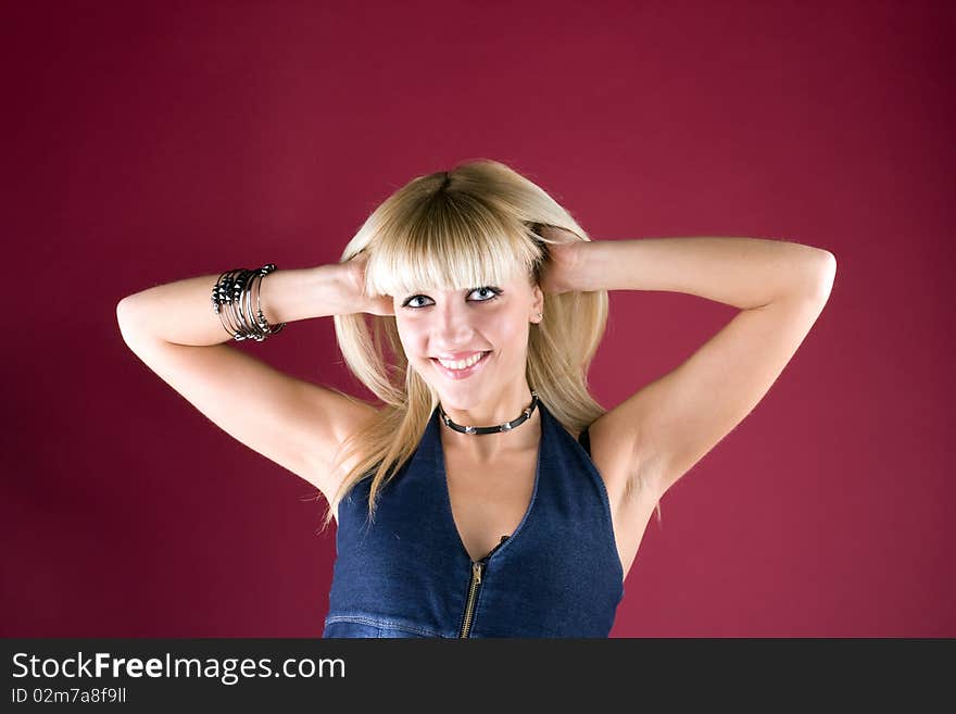 Portrait of a smiling blonde on red background