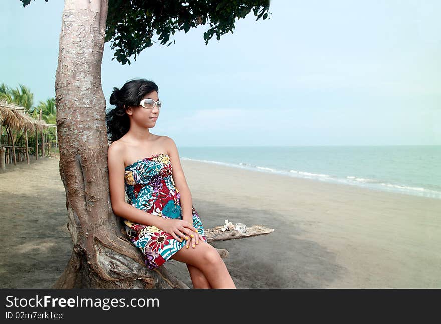 Happy asian lady looking out into the sea. Happy asian lady looking out into the sea