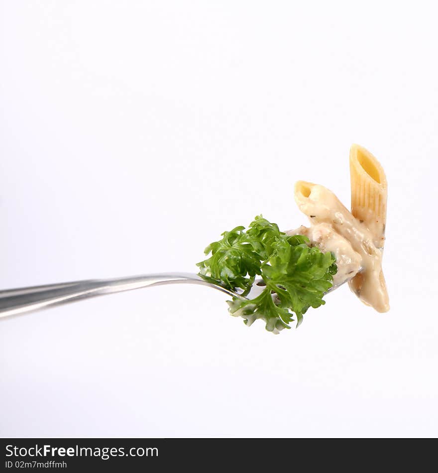 Penne with white sauce on a fork