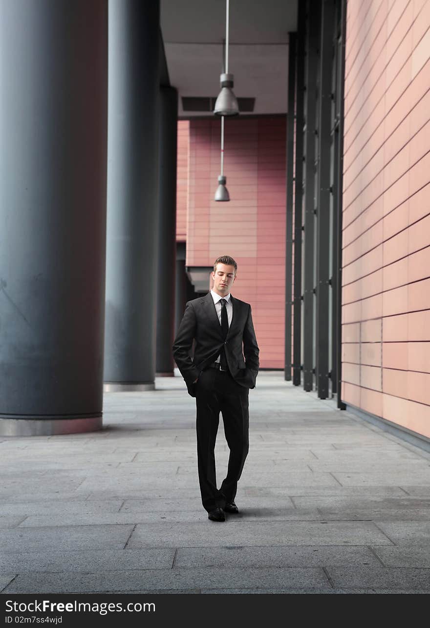 Businessman walking by an office building