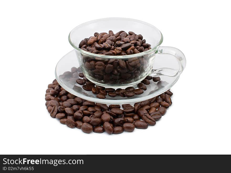 Coffee beans in a cup and on the plate, white background isolated. Coffee beans in a cup and on the plate, white background isolated