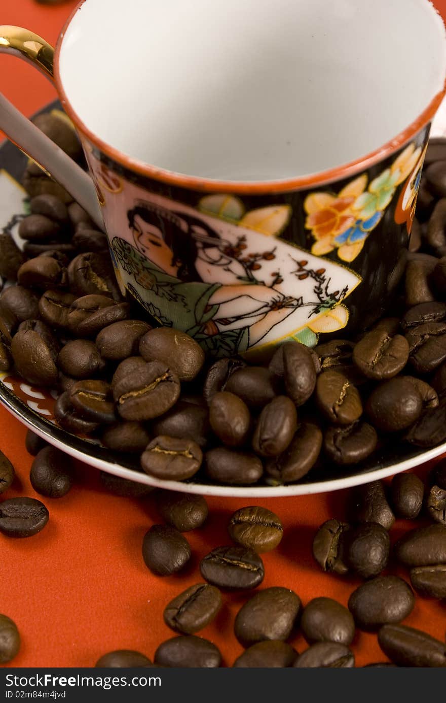 Coffee beans and empty cup