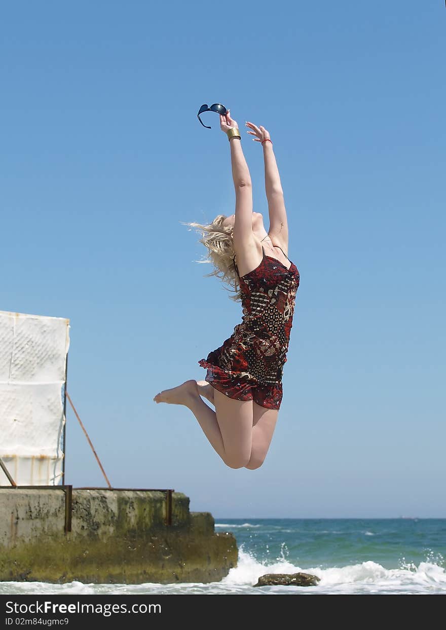 Woman jumping on the beach