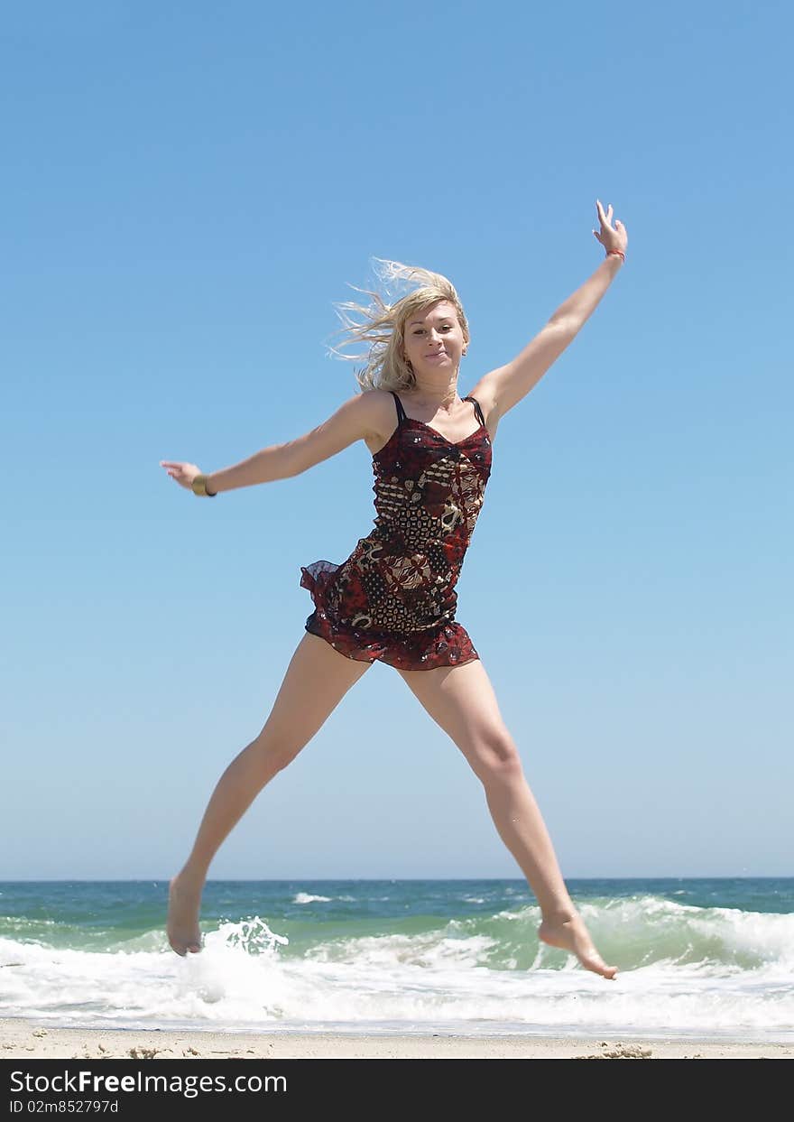 Woman jumping on the beach