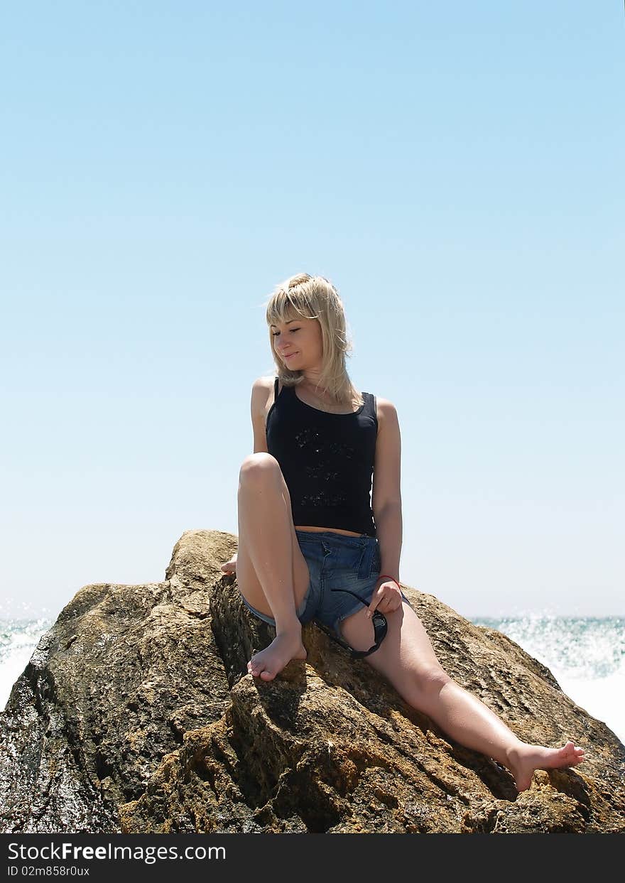 Young blonde woman vacationing at the beach. Young blonde woman vacationing at the beach