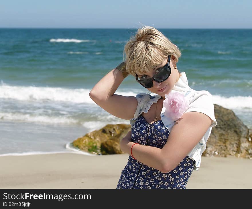 Young blonde woman vacationing at the beach. Young blonde woman vacationing at the beach