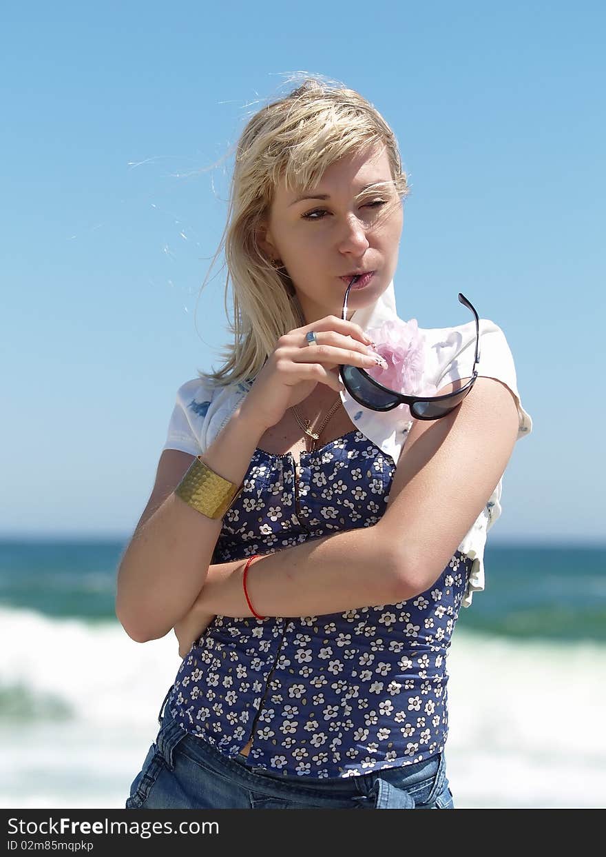 Young blonde woman vacationing at the beach. Young blonde woman vacationing at the beach