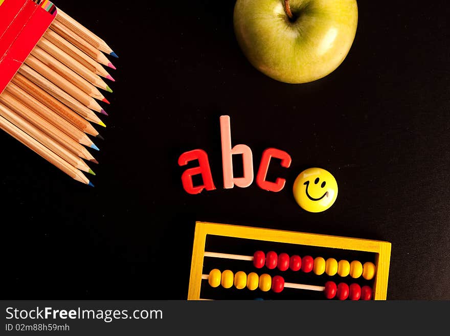 School equipment on blackboard arranged in studio. School equipment on blackboard arranged in studio