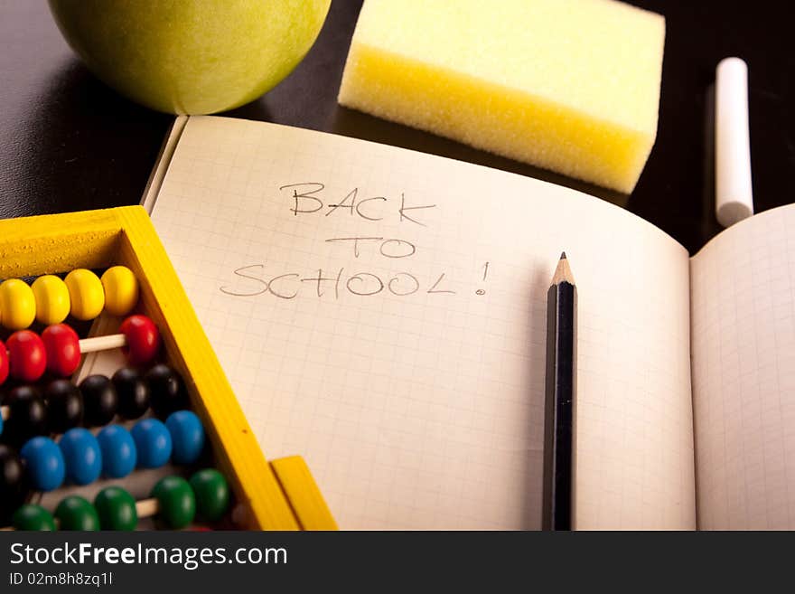 Education concept, black board, chalk and notebooks. Back to school!