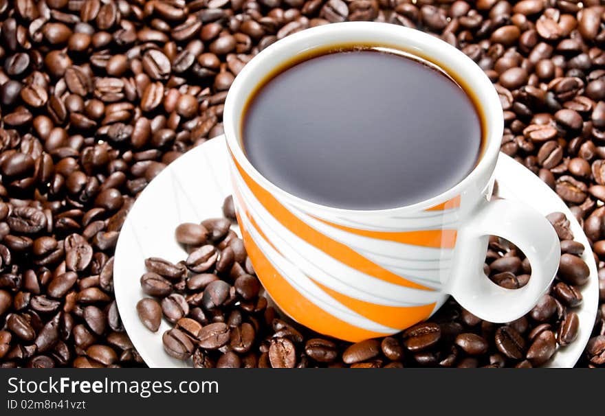 Coffee cup over coffee beans. Coffee cup over coffee beans