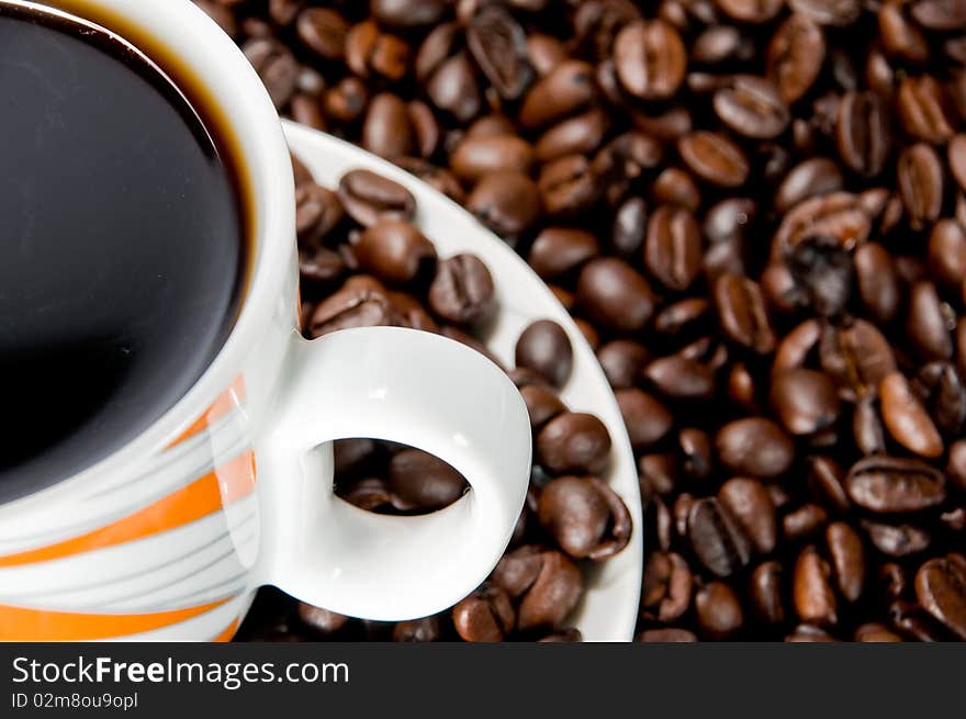 Coffee cup over coffee beans. Coffee cup over coffee beans