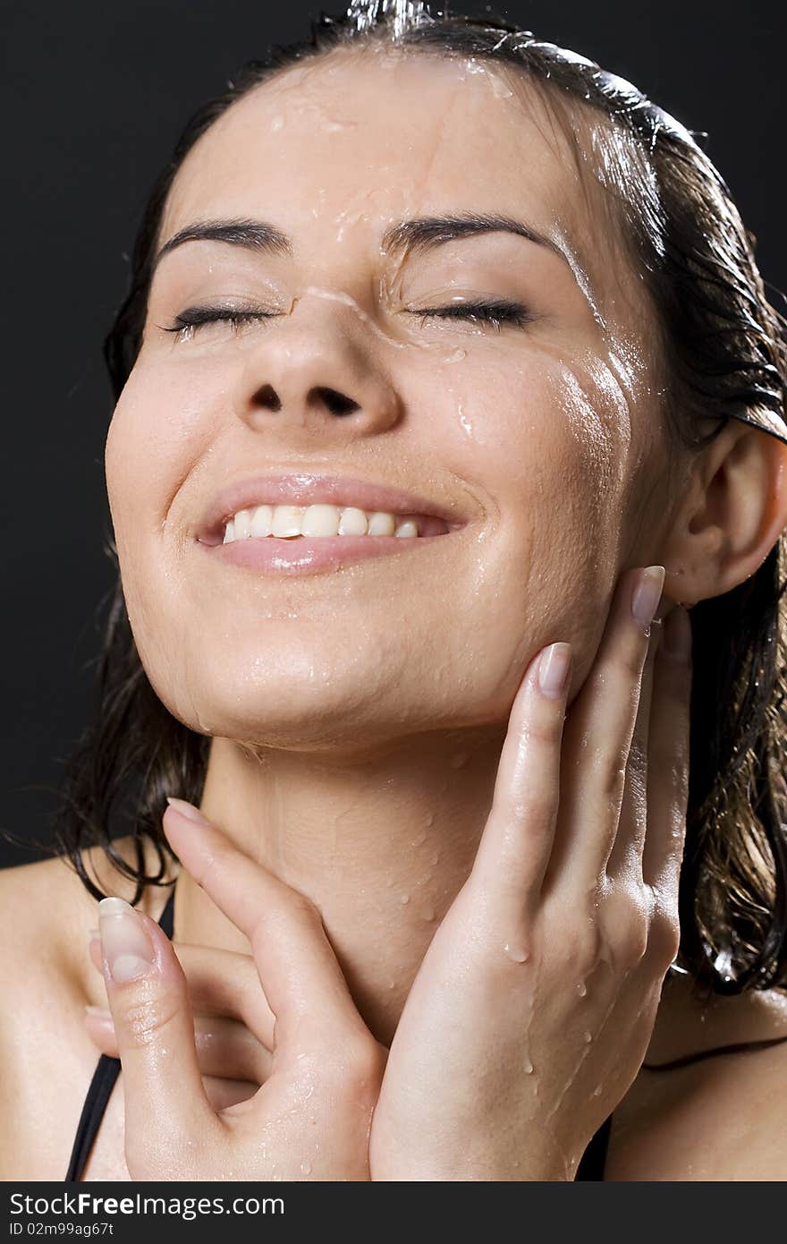 Portrait of the smiling brunette in drop of water on black background. Portrait of the smiling brunette in drop of water on black background