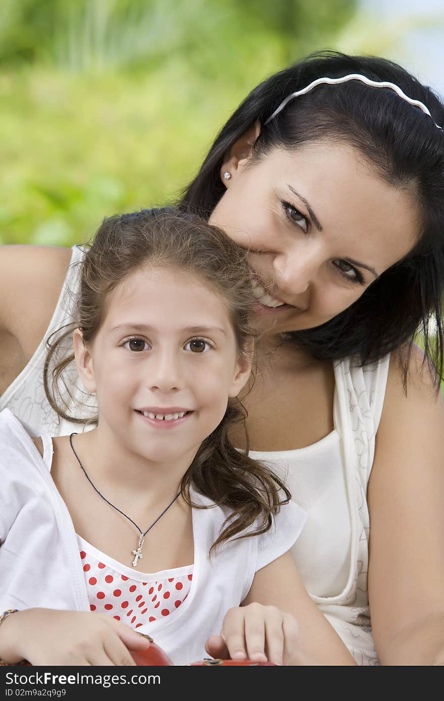 Portrait of happy mother with daughter  having good time in summer environment. Portrait of happy mother with daughter  having good time in summer environment