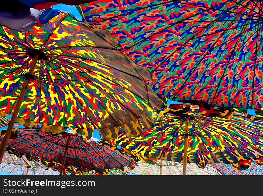 Under colurful umbrella on the beach of Thailand