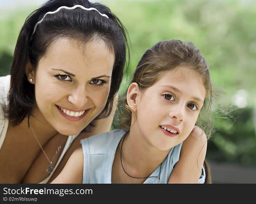 Portrait of happy mother with daughter having good time in summer environment. Portrait of happy mother with daughter having good time in summer environment