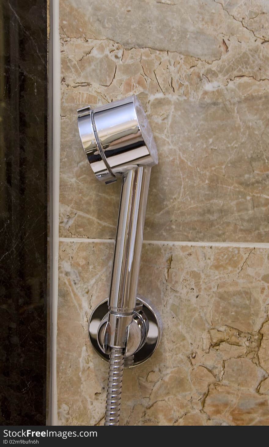 Chrome-plated sprinkle shower at the bath marble wall