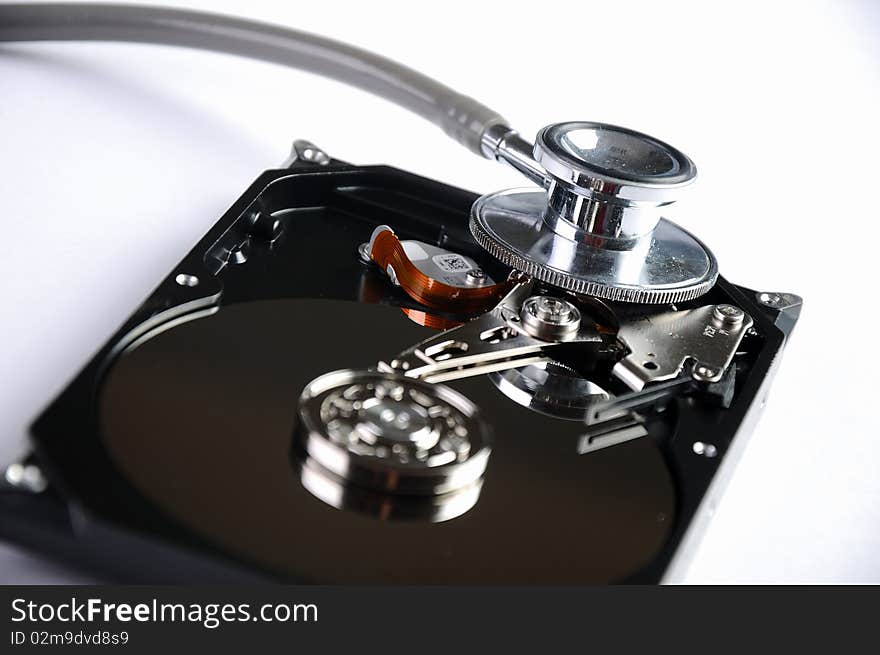 Computer hard drive and a stethoscope. The symbol of health equipment.