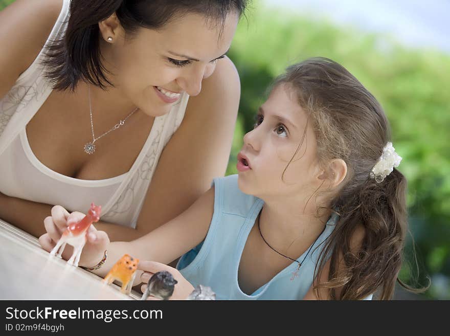 Portrait of happy mother with daughter  having good time in summer environment. Portrait of happy mother with daughter  having good time in summer environment