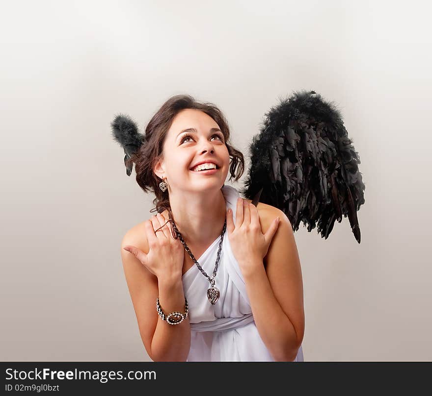 Brunette girl is posing and playing an angel. Brunette girl is posing and playing an angel