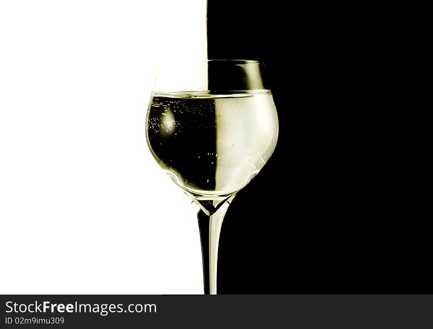 Two glasses with water, black and white background.