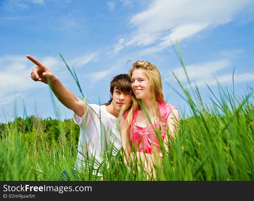 Couple sit in a grass