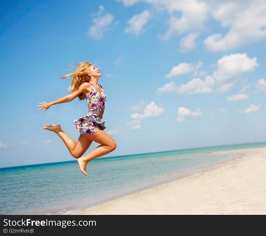 Young attractive girl jumping on beach. Young attractive girl jumping on beach