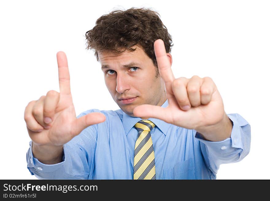 Young photographer trying to compose a frame for photograph using his hands, studio shoot isolated on white background