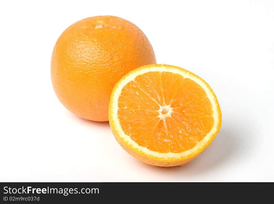 Two oranges, one intersected. With clipping path